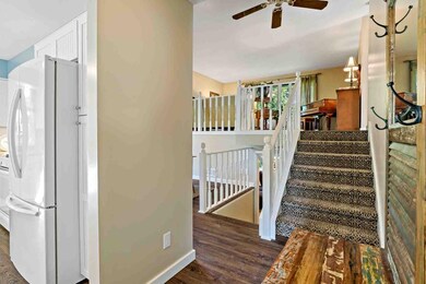 Foyer is welcoming with white woodwork, on trend f