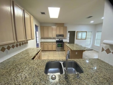 Kitchen with electric range, under cabinet range 