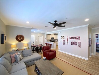 Living room with ornamental molding, baseboards, a