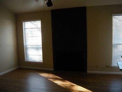 Spare room featuring ceiling fan, wood finished f