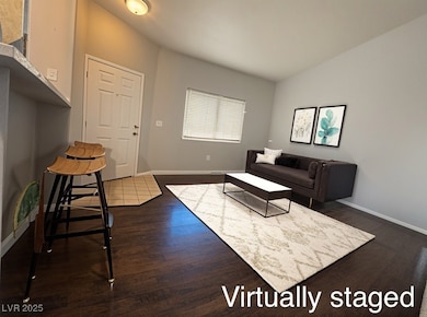 Living room featuring baseboards and dark wood-sty