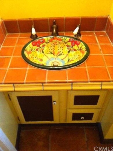 Spanish style sink and tile in the full guest bath
