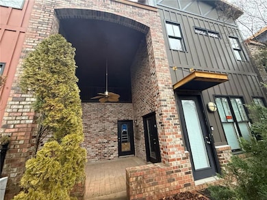 Back of property featuring ceiling fan