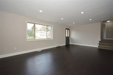 Looking towards the front door and stairs leading 