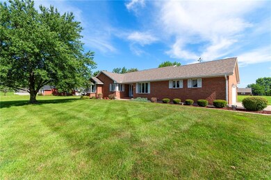 Single story home featuring brick siding and a front yard