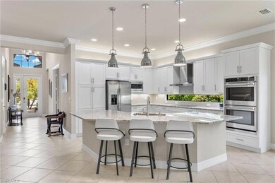 Kitchen featuring wall chimney range hood, stainle