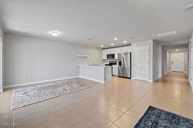 Unfurnished living room featuring recessed lighting, light tile patterned flooring, baseboards, and visible vents