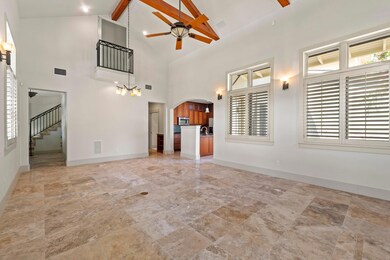 Unfurnished living room with arched walkways, hig