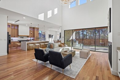 Living room with sink, light wood-type flooring, a