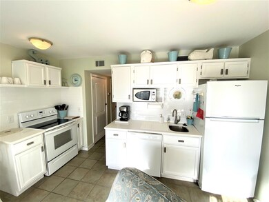 Kitchen featuring tasteful backsplash, white appli