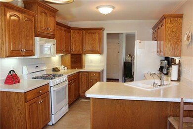 The kitchen  11x19 with oak cabinets and lots of counter space. The end of the counter has bar seating. 