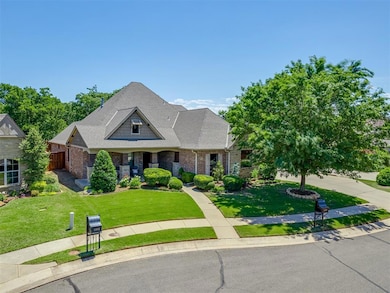 Craftsman-style home featuring brick siding a large front porch, a wonderful lot location, with lush landscaping and a good driveway.