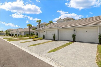 Multi unit property with a tile roof, community garages, a residential view, and stucco siding