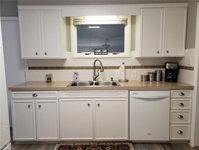 Freshly painted cabinets, new LVPs, tile backsplash and updated faucet in kitchen.