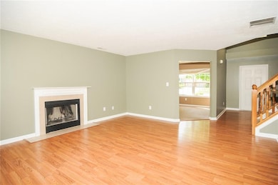 Living Room is big and bright featuring a wood-burning fireplace.