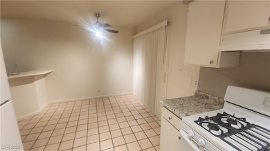 Kitchen with white range with gas stovetop, range