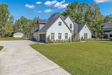 Charming two-story brick home with a well-maintained lawn, surrounded by trees and NO back neighbors!