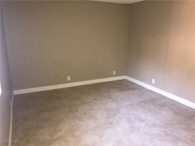 Empty room featuring baseboards