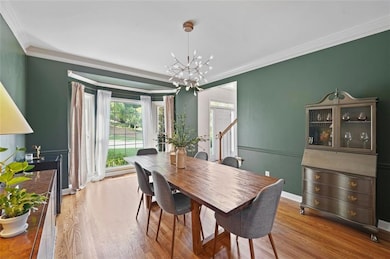 Dining space with a chandelier, ornamental molding