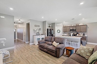 Living room featuring light wood-look tile floors