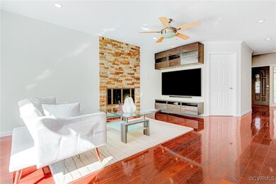 Living room with ornamental molding, a fireplace,
