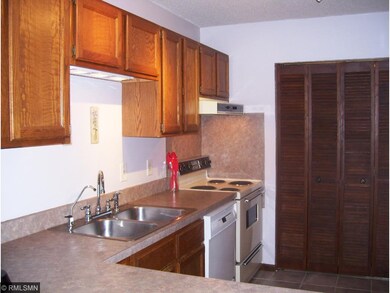 Kitchen view from dining room cutout. Door at far 