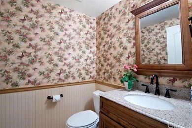 Main floor powder room is located off the kitchen.