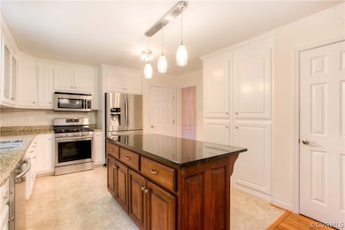 The beautifully renovated Kitchen boasts raised-panel cabinets with built-in spice rack, granite counter tops, stainless appliances, new lighting and tons of storage and pantry space. This could be your dream Kitchen!