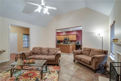 With vaulted ceilings and neutral tile floors his 