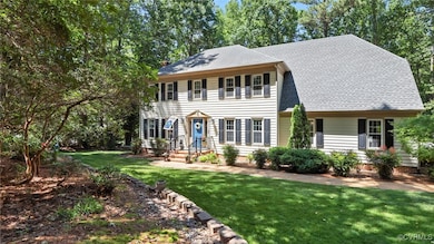 Colonial inspired home with a front lawn and roof