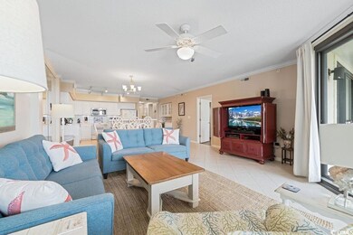 Living room with a chandelier, ornamental molding, a ceiling fan, and light tile patterned floors