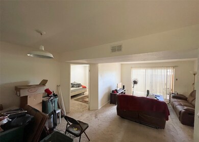 Front entrance of unit. Living room and dining roo