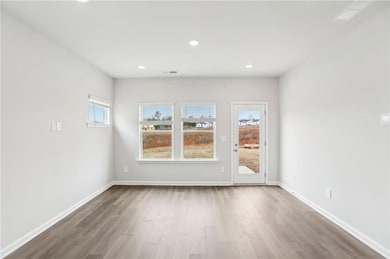 Empty room featuring wood-type flooring