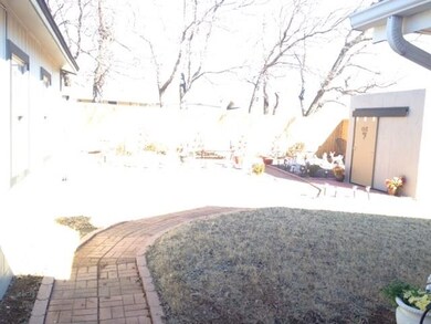 Large backyard with brick pathway throughout yard 
