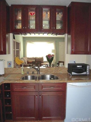 The kitchen also features wine shelves, cabinetry 