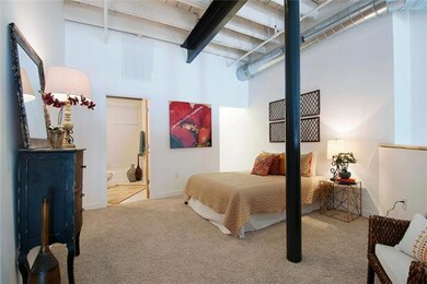 Lofted master bedroom suite includes a walk-in closet and private master bath. You will love the views of the exposed brick walls and architectural windows.