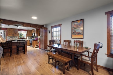 Dining room with light wood finished floors, healthy amount of natural light, rail lighting, and recessed lighting