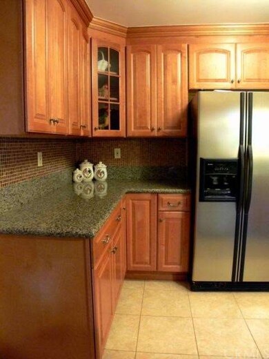 Remodeled kitchen with tile backsplash.