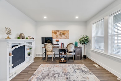 Office space with wood finished floors and recessed lighting