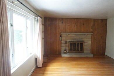Living room viewed from entry with wood burning fi