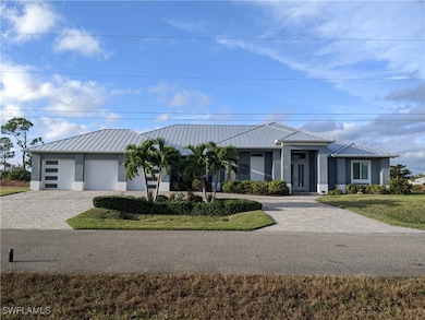 View of front of property featuring a garage, a st