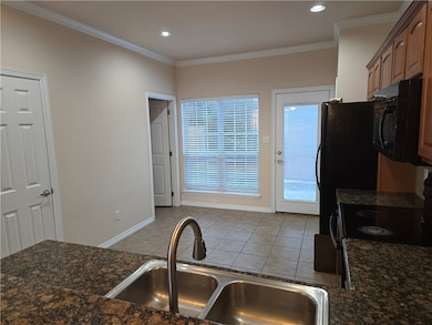 Kitchen featuring crown molding, light tile patter
