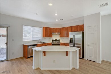 Kitchen featuring visible vents, light wood finish