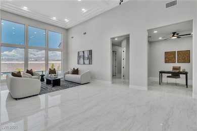 Living area featuring a high ceiling, marble finis