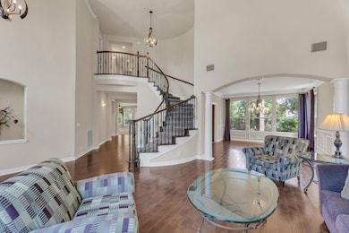 Living area featuring a chandelier, ornate column