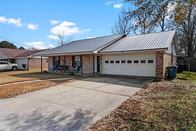 Ranch-style home featuring a garage and a porch