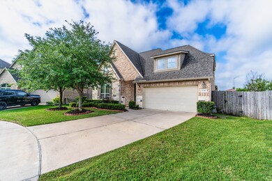 An inviting front yard with a spacious driveway, a