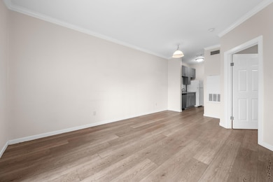 Unfurnished living room with light wood-style flo