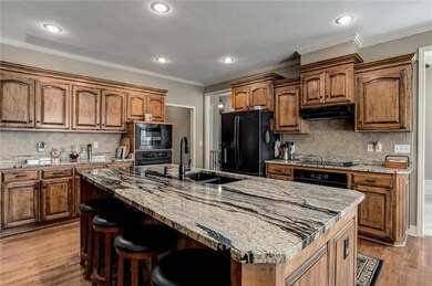Kitchen with double ovens and stone counters
