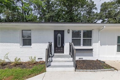Property entrance featuring brick siding and crawl space
